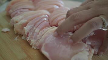 cutting chicken fillet on a chopping board video