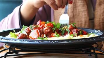 woman hand fork pick Turkey Meatballs on a plate video