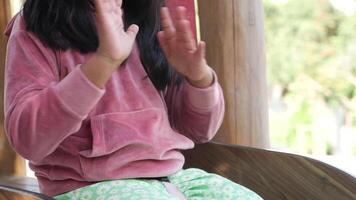 child clapping hands and smiling, sitting on sofa . video