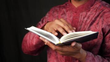 man holding Holy book Quran close up video