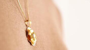 a locket around young woman's neck, close-up. video