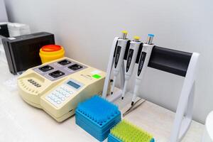 Blood test in the laboratory. Laboratory work with dispensers. Vacuum tubes for blood. Closeup. photo