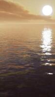 twilight sky in colorful bright sunlight reflects off on the water surface video