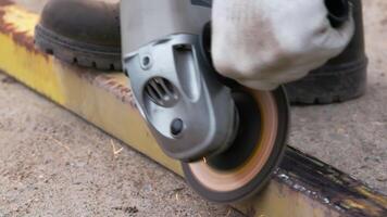 yellow rusted square steel pipe is being cleaned with angle grinder and flap disc video