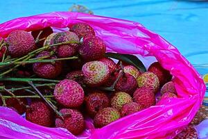 Malaysian fresh lychee fruits, sometimes called lychee nut or litchi, are sweet and juicy. Known as the queen of fruits, this exotic, seasonal delight is sold at hawker stalls and markets. photo