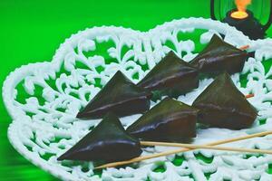 Legendary Malaysian recipe featuring fish, coconut shreds, and chili, wrapped in banana leaves, and steamed. Served at hawker stalls for meals or breakfast. photo