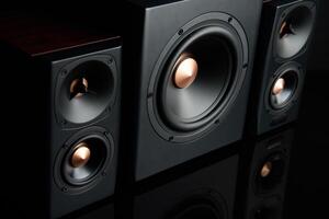 Sound audio system with two satellites and subwoofer on dark background. photo