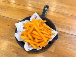 Cheddar Cheese Poured or Pulled from on top Deep Fried French Fries photo