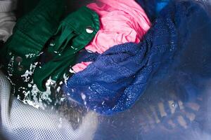 Clothing in the water while being laundered in the washing machine photo