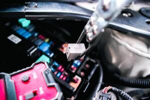 Car electromagnetic relay switch removed with relay removal pliers for testing with a relay tester , Concepts about automotive electronic components photo