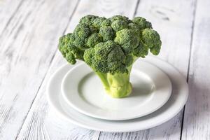 Fresh broccoli on the white plate photo