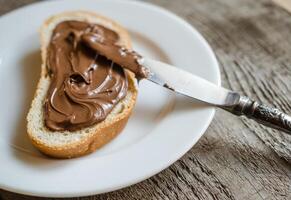 Slice of bread with chocolate cream photo