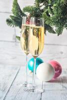 Two glasses of champagne with Christmas tree branch photo