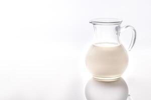 A jug of milk on the white background photo