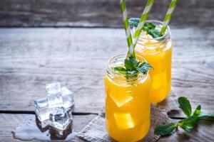 Glass jars of mango juice photo