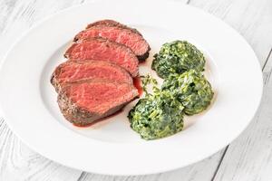 Flank steak with creamy spinach photo