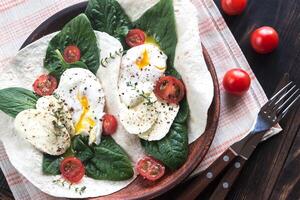 Tortilla sandwiches with poached eggs photo