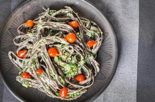 Black pasta with spinach, mascarpone and Parmesan photo