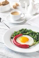 Fried egg with spinach and fresh chilli photo