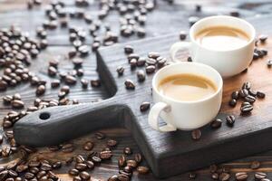 Two cups of coffee with coffee beans photo