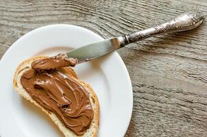 Slice of bread with chocolate cream photo
