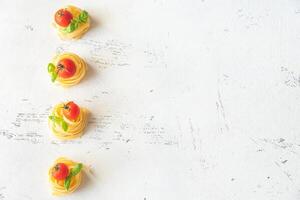 Raw fettuccine with tomatoes photo