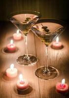 Two olive martini cocktails in the candlelight photo