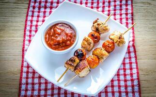 Grilled chicken skewers with cherry tomatoes photo