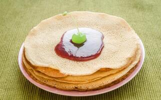 Crepes under cherry topping photo