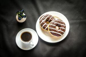 Chocolate donuts with a cup of coffee photo