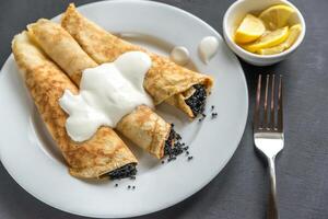 Crepes with black caviar photo