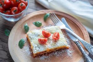 Lasagna with cherry tomatoes and fresh basil photo