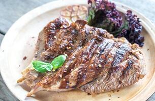 Grilled turkey on the wooden board photo