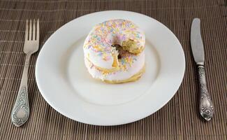 Donut with chunk bitten off photo