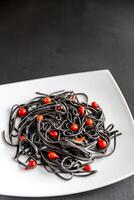 Pasta with wheat germ and black cuttlefish ink photo