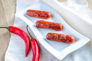 Roasted sausages on the plate photo