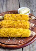 Grilled corn on the wooden board photo