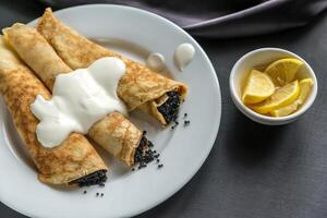 Crepes with black caviar photo