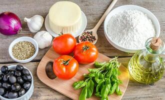 Ingredients for pizza on the wooden background photo