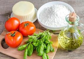 Ingredients for pizza on the wooden background photo