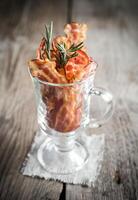 Fried bacon strips with fresh rosemary photo