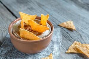 A bowl of hummus with corn chips photo