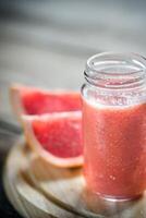 Glass jar of grapefruit smoothie photo
