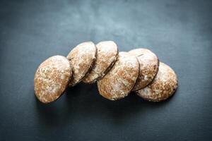 Gingerbread cakes on the wooden background photo