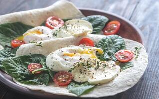 Tortilla sandwiches with poached eggs photo