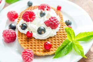 Belgian waffles with whipped cream and fresh berries photo