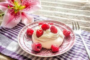 Meringue with fresh raspberries photo