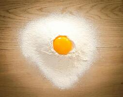 Broken egg in flour photo