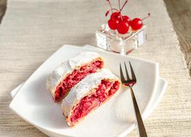 Cherry strudel on the square plate photo