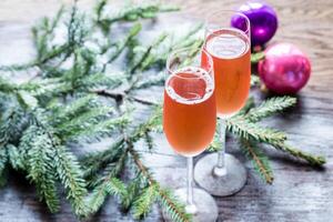 Two glasses of champagne with Christmas tree branch photo